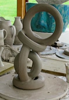 some white vases sitting on top of a table