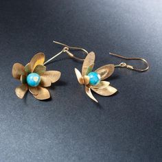 Earrings from the MEADOW collection - flowers with jade and brass petals hanging on a 925 silver ear hook - length 6 cm with ear hook. We make jewelry by hand according to our own designs in the Anillo workshop. The necklace is shipped in an elegant box. Jewelry for women connected with nature, women - flowers, women - birds, women - butterflies :) Brass Drop Earrings With Flower Charm, Elegant Brass Flower Earrings Nickel Free, Brass Flower Charm Earrings, Brass Flower Drop Earrings, Handmade Brass Flower Earrings, Handmade Elegant Brass Flower Earrings, Silver Brass Flower Earrings, Elegant Handmade Brass Flower Earrings, Unique Brass Flower-shaped Jewelry