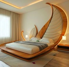 a bedroom with a bed that is shaped like a bird's wing and has a large window behind it