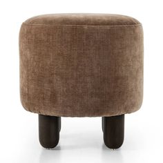 a brown ottoman sitting on top of a white floor