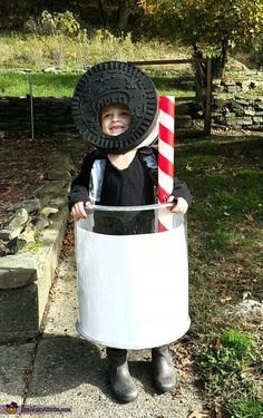 a little boy dressed up as an oreo cookie holding a candy cane