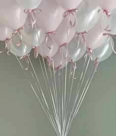 a bunch of pink and white balloons tied together