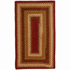 a red and beige rug with an oval design