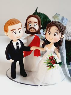 a wedding cake topper with a bride and groom holding each other's hand