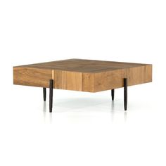 a wooden coffee table with black legs and an end table on one side that has a drawer in the middle