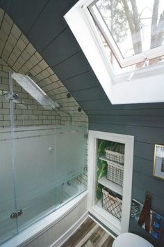 a bathroom with a skylight above the bathtub