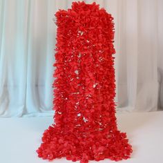 a tall red object with flowers on it