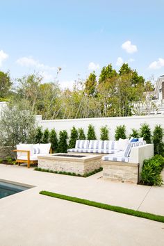 an outdoor living area with couches and a pool