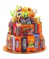 a multi tiered cake made out of candy bars and candies is displayed on an orange plate