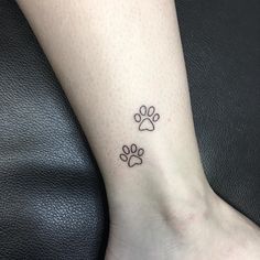 a dog paw tattoo on the ankle