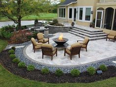 an outdoor patio with chairs and fire pit