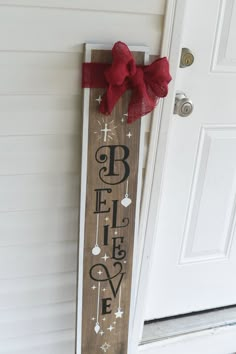 a wooden sign that says hope on it with a bow hanging from the front door