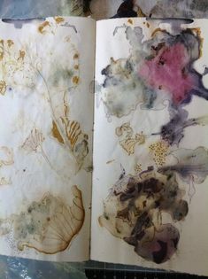 an open book that has been altered to look like it is covered in watercolor and ink