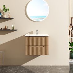 a bathroom with a round window, sink and shelves on the wall next to it