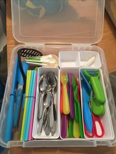 a plastic container filled with lots of different colored utensils