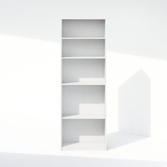 an empty white book shelf in the middle of a room