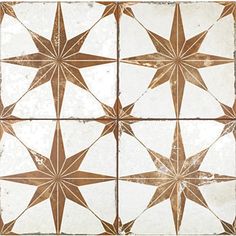 a white and brown tiled wall with star designs on the top, bottom and bottom