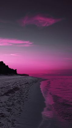 the beach is covered in footprints as the sun sets