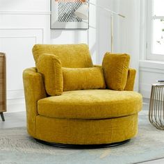 a yellow chair sitting in a living room next to a lamp