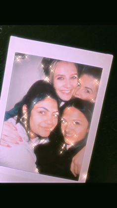 three women are posing for a photo with lights on their head and one woman has her arm around the other's shoulder