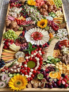 a very large tray filled with lots of different types of fruits and veggies