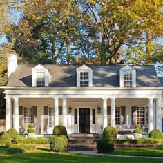 a white house with columns and pillars on the front porch is featured in this postcard