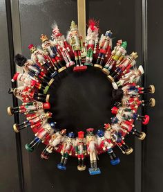 a wreath made out of nutcrackers is hanging on the door