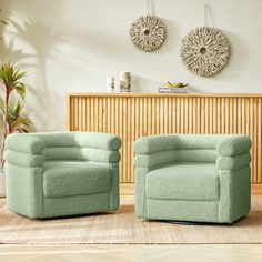 two green chairs sitting next to each other on a rug in front of a wall