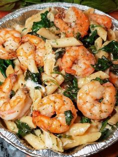 pasta with shrimp and spinach in a pan