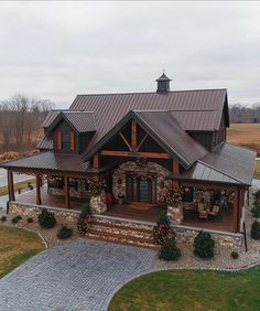 an aerial view of a house with christmas decorations on the front porch and covered patio