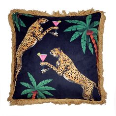 two cheetah drinking martinis on a pillow with fringe trim