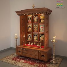 a wooden cabinet with pictures on it and candles in the corner next to each other