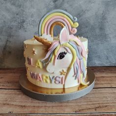 a birthday cake decorated with an image of a unicorn