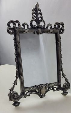 an ornate mirror sitting on top of a table