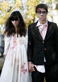 a man and woman dressed up as zombies