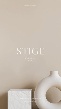 a white vase sitting on top of a table next to a small square box with the word'stge medical spa '