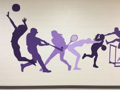 a mural on the side of a building depicts people playing tennis and basketball in silhouettes