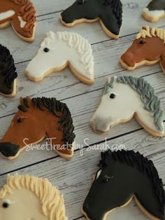 decorated cookies in the shape of horses on a table