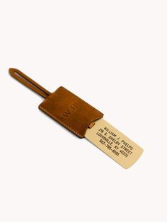 a brown luggage tag with a leather strap