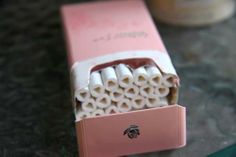 a pink toothbrush holder sitting on top of a counter