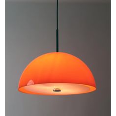 an orange pendant light hanging from a ceiling