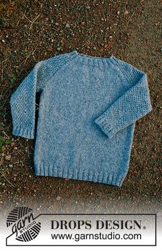 a blue sweater laying on the ground