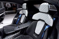 the interior of a car with black leather and blue stitching on the front seats