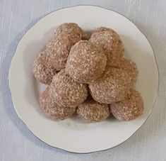 a white plate topped with donuts on top of a table