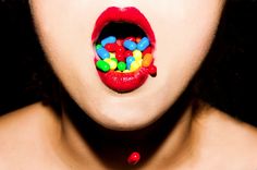 a woman's mouth with candy on it