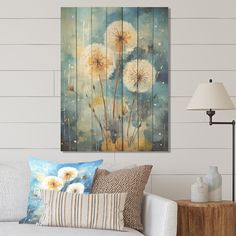 a living room scene with focus on the dandelions and wooden planks wall