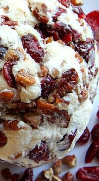 a white plate topped with bread covered in nuts and raisins