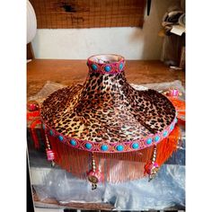 a leopard print lamp shade with tassels and beads