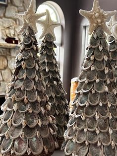 two small christmas trees made out of seashells