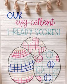 an egg - cellent sign is hanging on the wall next to a piece of paper that says, our egg - cellent 1 - ready score